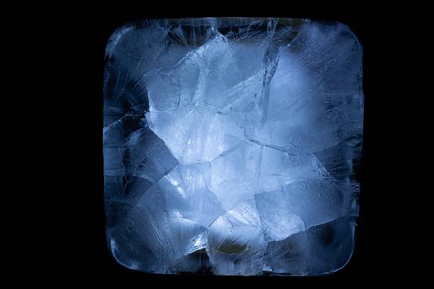 The mesmerizing beauty of a crystalline structure is revealed in an unusual perspective; capturing light and shadow within its frozen form, inviting contemplation