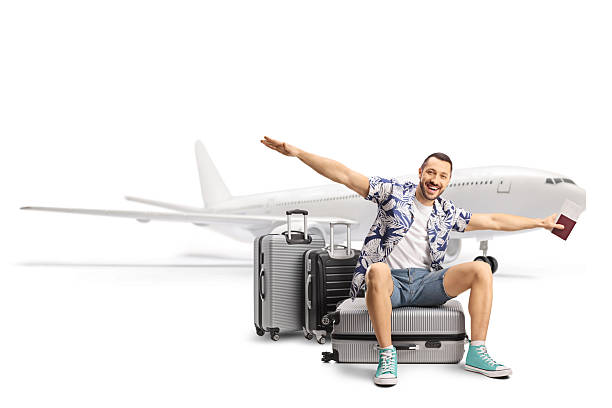 istock Male tourist sitting on a suitcase and spreading arms while waiting for a flight 2255877810