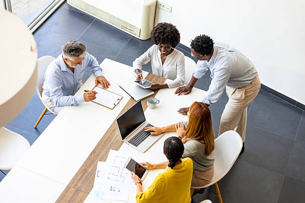 istock Team Meeting In Modern Office With Laptop, Tablets, And Collaborative Energy 2255884869