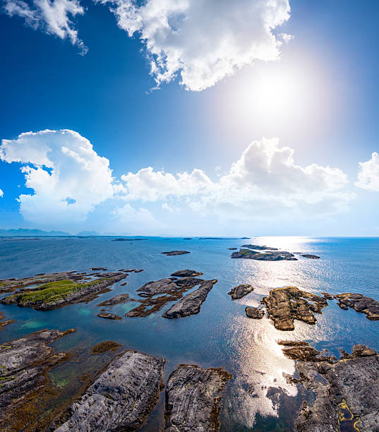 Bud Hustadvika aerial view of rocky skerries and Atlantic Ocean with sun reflection at sunset, Norway, summer