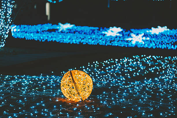 Bright glowing orange woven orb in a magical night setting with numerous sparkling blue lights.