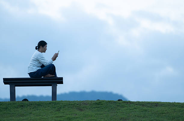 Young man on a bench, looking at the sea.