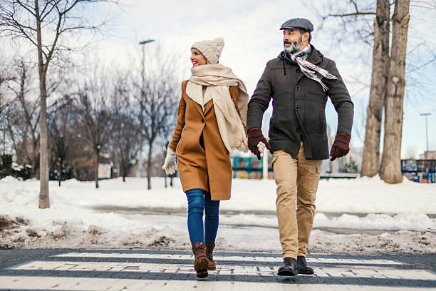 istock Mature couple walking hand in hand during winter 2255898920