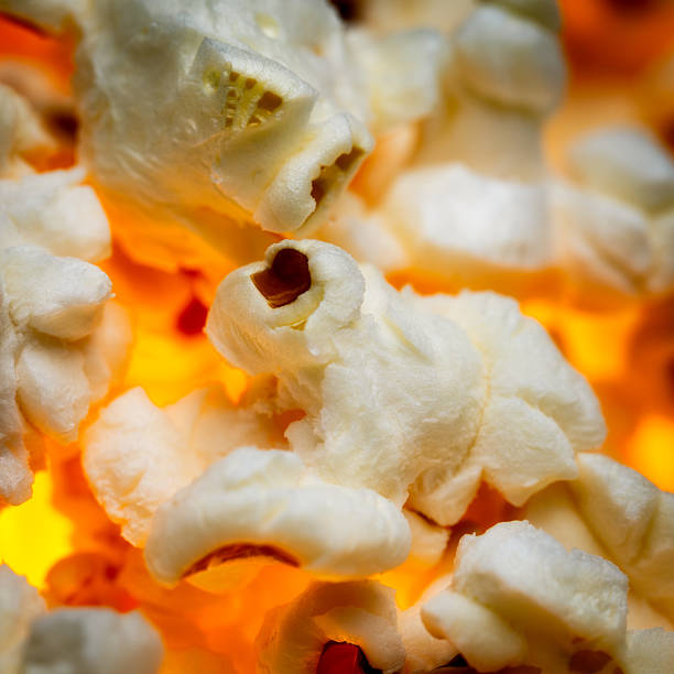 Close-up of popcorn with glowing orange background.