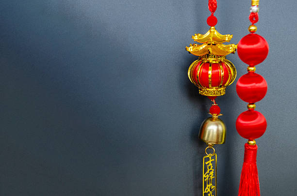 Hanging lantern with plum blossom accents on dark background for elegant festive composition