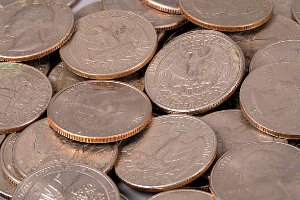 Close-up of a 1967 US quarter coin showing 'Liberty' and 'In God We Trust'.