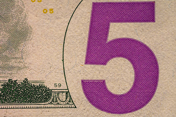 istock Close up of a five-dollar bill showing the number five 2255908196