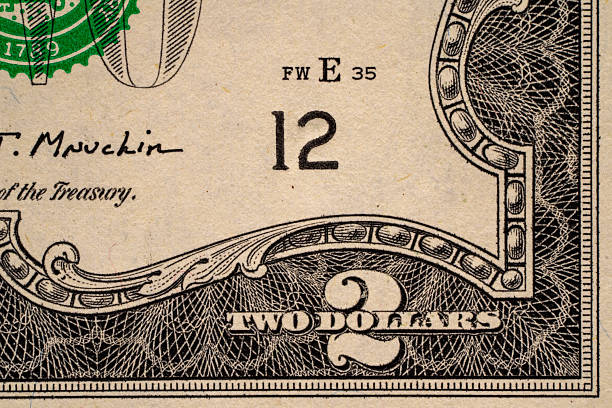 Two dollar bill details with serial number and signatures