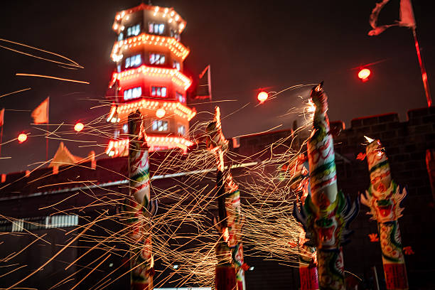 Wind-scattered oversized incense sparks glow and flee during Chinese New Year celebration.