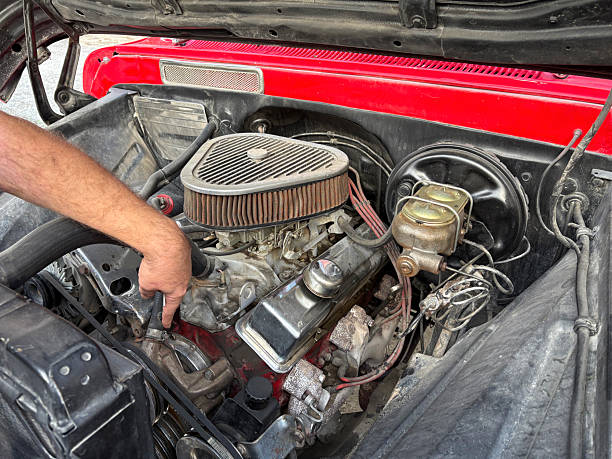 istock Repairman pointing out the problem in the vintage car's engine 2255913896