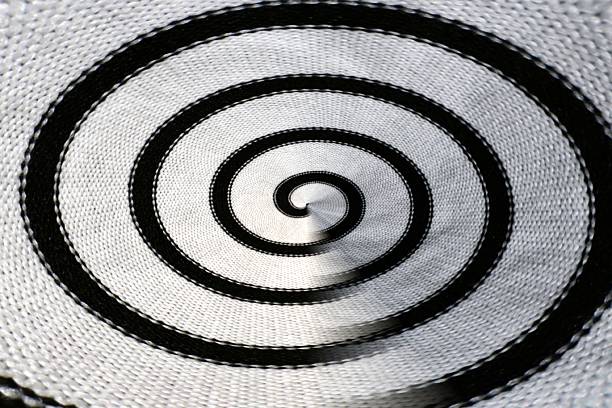 Abstract black and white spiral fabric texture background with concentric curves, woven textile detail, optical illusion effect, and strong contrast, ideal for modern, artistic, or conceptual designs.