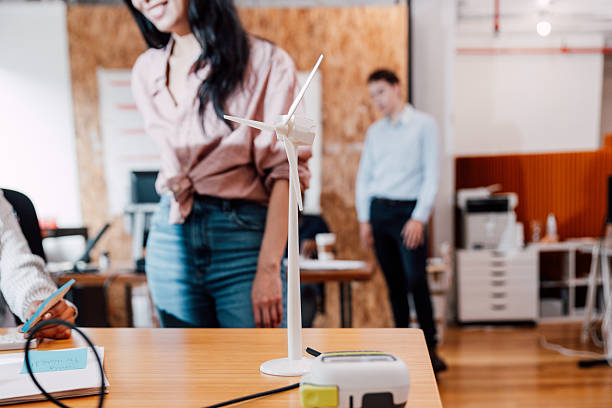 istock Diverse coworkers working with renewable energy model in modern startup office 2255917125