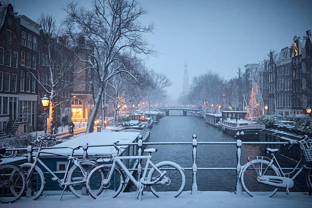 Snowy Amsterdam by night in the Netherlands with the Westerkerk