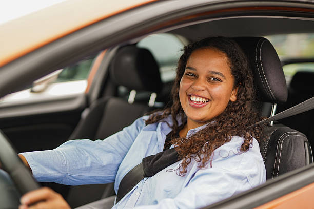 istock Happy young african girl smiling on camera while sitting inside a car - Driving licence, transportation and young people lifestyle concept 2255920201