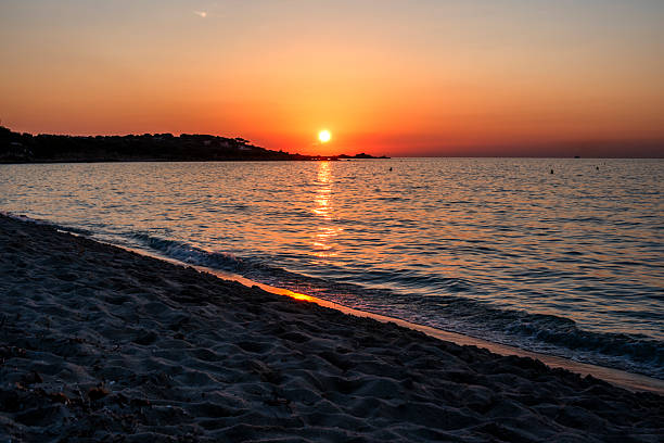 Minimal Mediterranean seascape with soft pastel sky and fading sunset light in Corsica, France. A clean and quiet composition suited for abstract backgrounds and branding use.