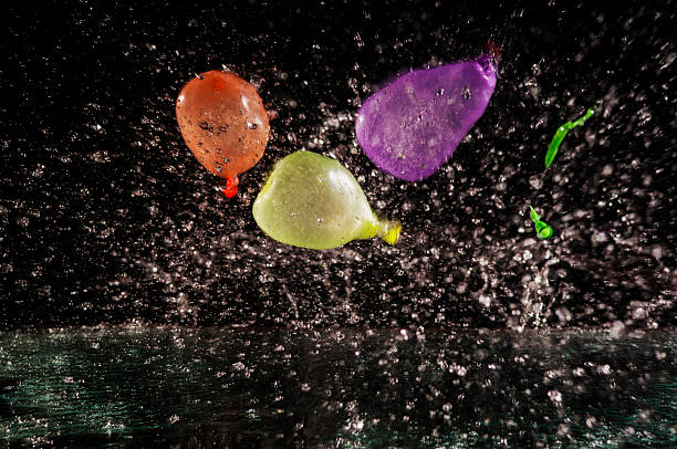 Close-up of a woman tying a water ballon at homeyard