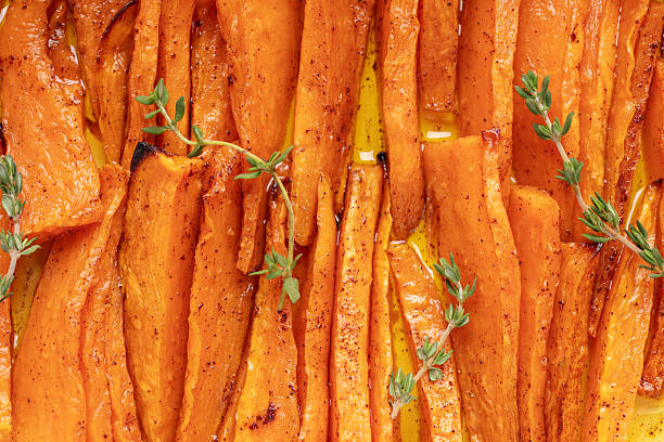 Baked sweet potatoes white thyme in a baking dish. Top view
