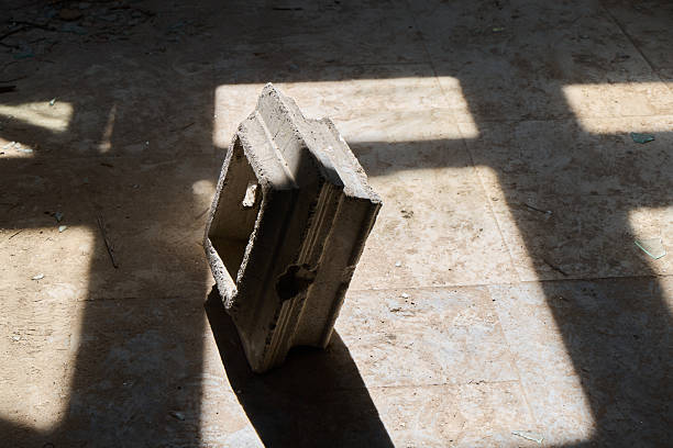Sunlit wooden crate on tiled floor, strong window shadows forming geometric grid and warm sunbeam. Dust motes visible in cinematic