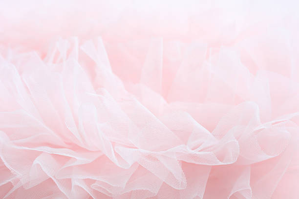 Delicate pink fabric layers create a gentle, dreamy texture.