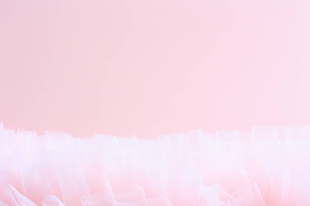 Delicate pink fabric creates a gentle, dreamy atmosphere.