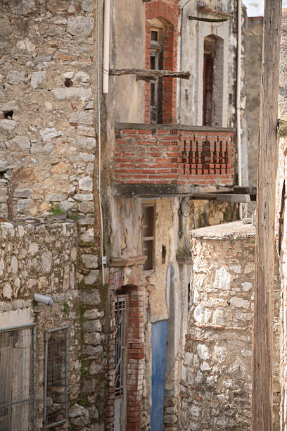 a lying brick on the ground. a secured construction site. demolition of an old red brick residential building in the city center. demolition of a residential building. a ruin, a falling apart building.