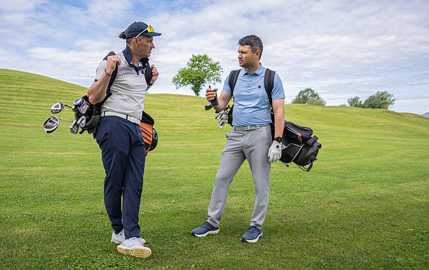 istock Relaxed Mature Caucasian Golfers Conversing on Scenic Course with Golf Equipment During Game Break 2255932123