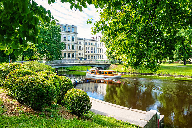 A tour boat moves in the city canal in Kronvalda Park, downtown Riga, Latvia.