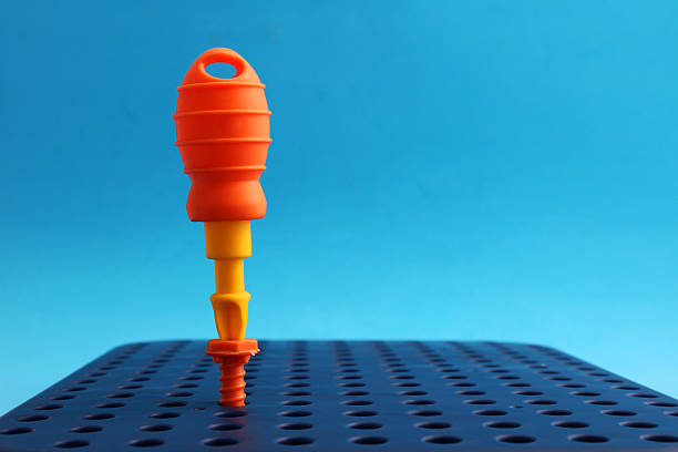 Colorful screwdriver screwing a nut