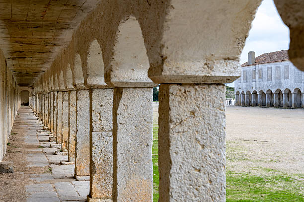 Cabo Espichel Sesimbra Portugal December 25 2025. Stone columns and arches form a covered arcade inside the historic sanctuary complex.