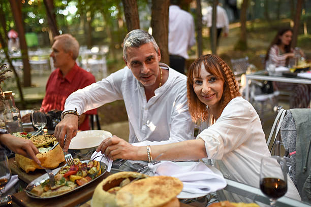 istock Friends sharing outdoor dinner in a forest setting 2255939413