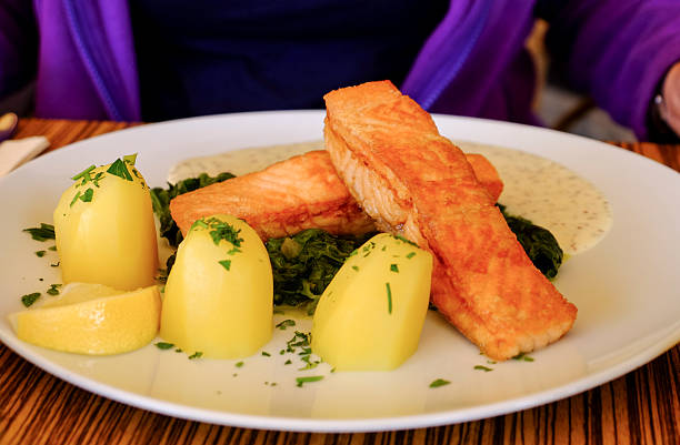 Plate with grilled salmon, potatoes and spinach