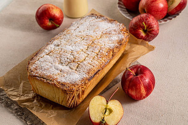 Classic apple pie presented on a wooden backdrop, styled as a traditional homemade dessert.