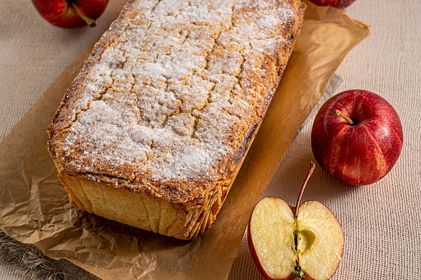 Classic apple pie presented on a wooden backdrop, styled as a traditional homemade dessert.