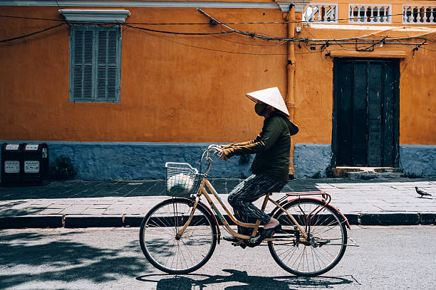 Simple photo of a women cycling in Saigon.