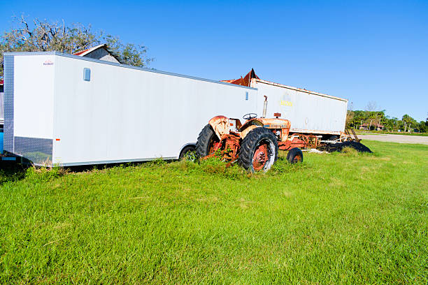 New Smyrna Beach, FL, USA, Landscape, some rusty tractors, and trailers in the field.