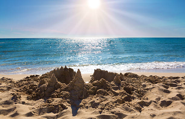 Sand castle on the seashore. Travel background.