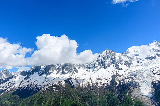 Two Mountain Climbers Assisting Each Other Amidst Snow-Covered Peaks in the Majestic Mont Blanc Massif