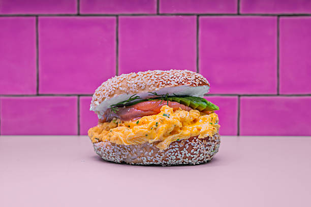 The perfect brunch combination: an onion bagel with a thick layer of Philadelphia cream cheese, sliced Norwegian salmon, thinly sliced cucumber, and a final touch of freshly ground black pepper.