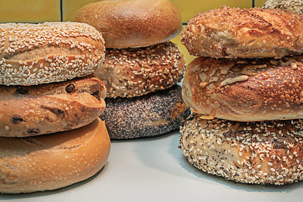 An innovative combination featuring an onion bagel spread with goat cheese, soy- and ginger-marinated salmon, and a topping of sliced avocado and black sesame seeds.