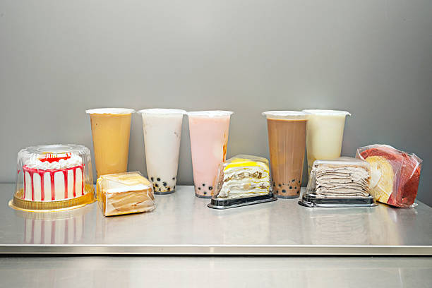 A rainbow bubble tea creation with syrups of different flavors and colors carefully layered in a tall glass, without mixing, forming vibrant horizontal bands