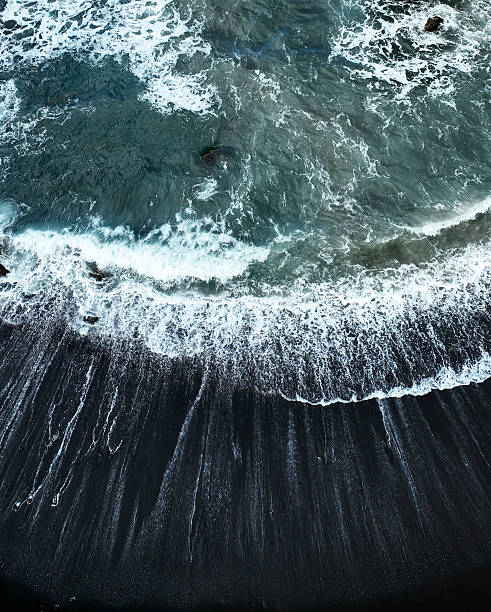 istock Atlantic ocean from above, waves and black basalt sand and rocks, view from a drone. 2255973763
