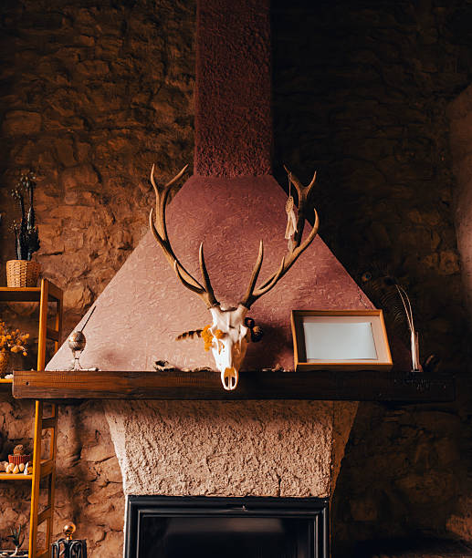 A stuffed Jackalope (rabbit with antlers) mounted on a wooden trophy with some retro vintage floral wallpaper.  Vertical with copy space.