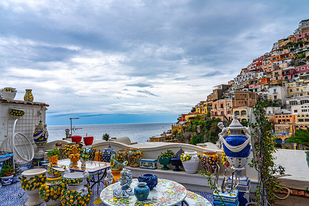 Amalfi old town and summer beach with umbrellas , Italy