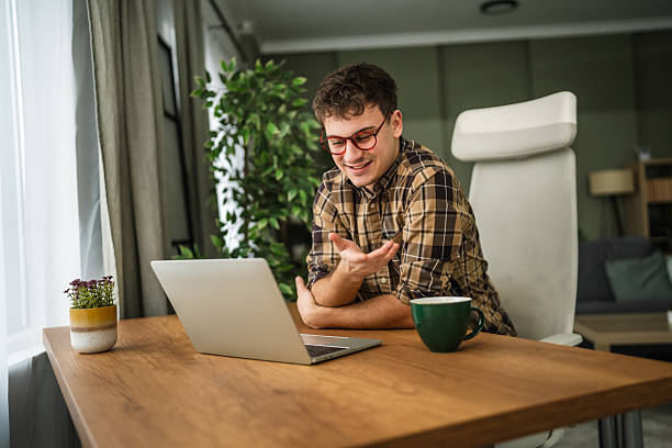 istock Young man having video call remote working from home 2255978217