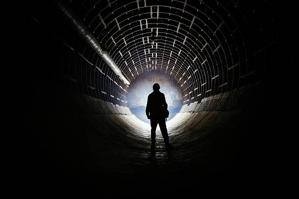 istock Silhouette of man in round abandoned bunker 2255979779