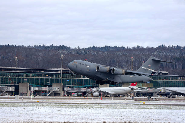 Military cargo airplane type Boeing C-17 Globemaster III registration 66163 leaving Swiss Zürich Airport on a winter day. Photo taken January 12th, 2026, Zurich, Switzerland.