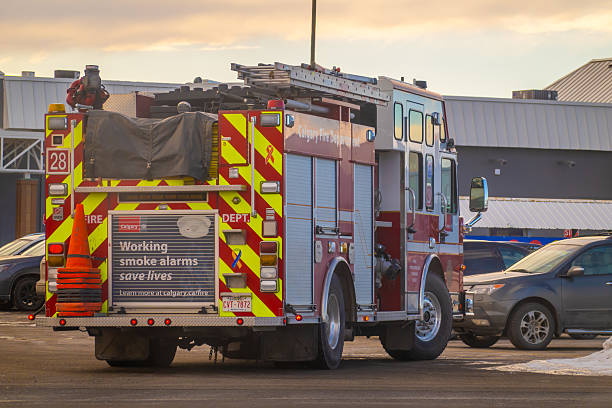 Calgary, Alberta, Canada. January 12, 2026. A Calgary Fire Department engine parked in a lot featuring a smoke alarm safety advertisement on the rear.
