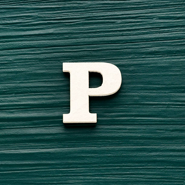 istock Alphabet letter P, white piece on a dark green rustic background 2255982555