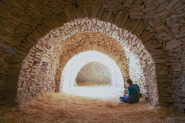 Woman sitting cross-legged, looking at the photos she took