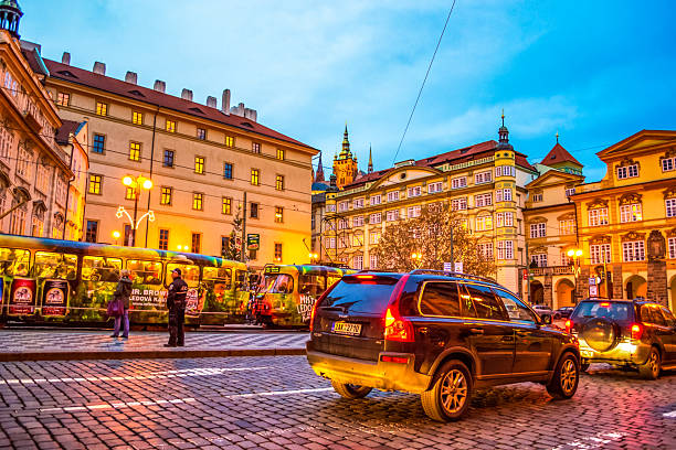 Prague,Czech Republic- December 18 2014:Road traffic at Beautiful evening Old Town Malostranske namesti square Prague city,Czech Republic,Central Europe,Since 1992, the extensive historic center of Prague has been included in the UNESCO list of World Heritage Sites